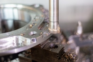 Milling a part on a CNC machine with a high-speed milling cutter.